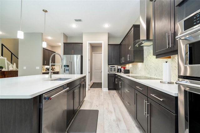 8066 Ludington Cir, Orlando, FL 32836 - kitchen featuring stainless steel appliances, wall chimney exhaust hood, tasteful backsplash, light countertops, and recessed lighting