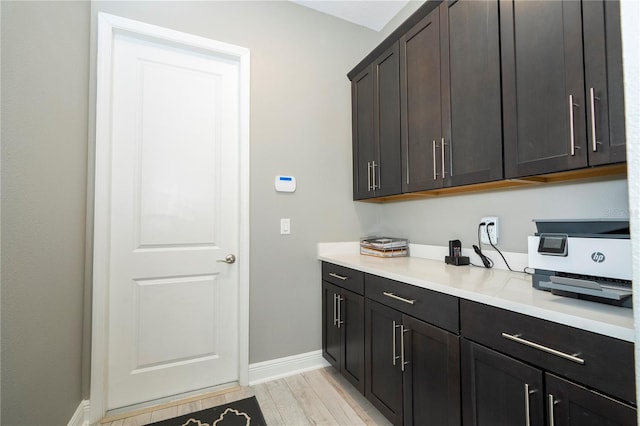 8066 Ludington Cir, Orlando, FL 32836 - laundry room featuring baseboards and light wood-type flooring