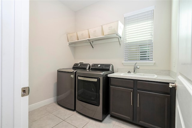 8066 Ludington Cir, Orlando, FL 32836 - washroom with washer and clothes dryer, light tile patterned floors, and cabinet space