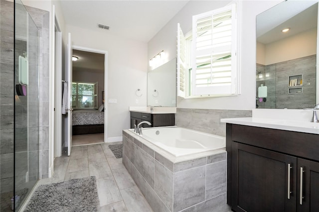 8066 Ludington Cir, Orlando, FL 32836 - bathroom with a bath, two vanities, a shower stall, and connected bathroom