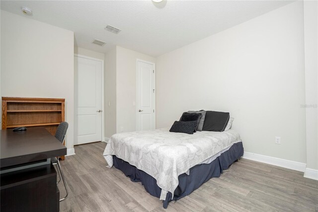 8066 Ludington Cir, Orlando, FL 32836 - bedroom featuring baseboards and wood finished floors