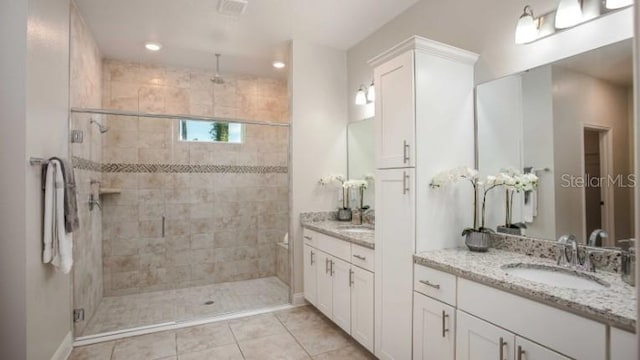 279 SW Cadence Gln, Lake City, FL 32024 - full bathroom featuring vanity, a stall shower, and tile patterned floors