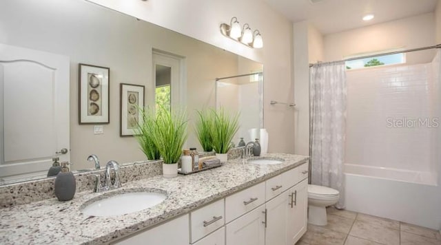 279 SW Cadence Gln, Lake City, FL 32024 - full bathroom featuring double vanity, shower / bath combo with shower curtain, and tile patterned floors