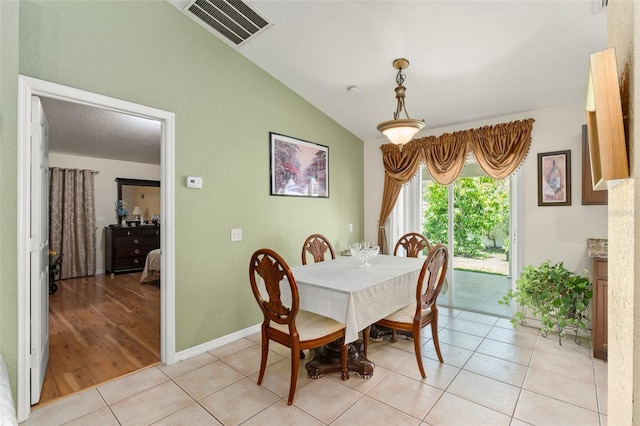 470 Cardinal Ct, Kissimmee, FL 34759 - dining area with vaulted ceiling and light tile patterned flooring