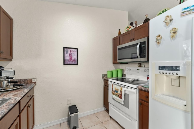 470 Cardinal Ct, Kissimmee, FL 34759 - kitchen with white appliances and light tile patterned floors