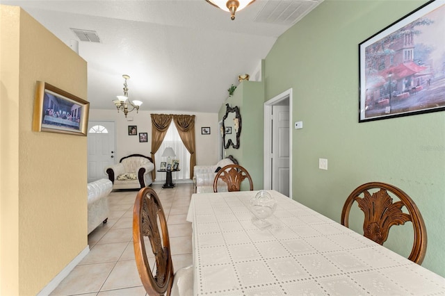 470 Cardinal Ct, Kissimmee, FL 34759 - dining area featuring light tile patterned flooring, vaulted ceiling, and a chandelier