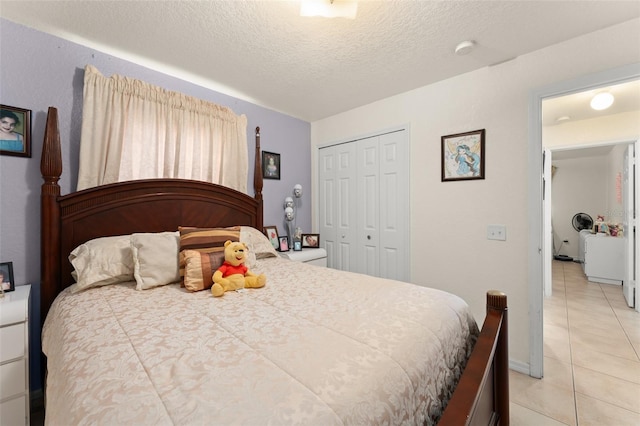 470 Cardinal Ct, Kissimmee, FL 34759 - bedroom featuring light tile patterned flooring, a closet, and a textured ceiling