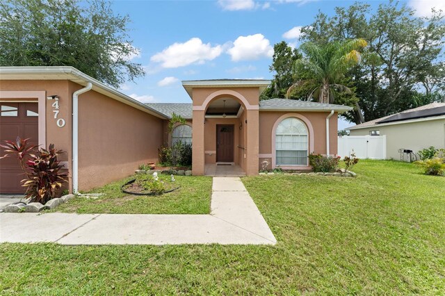 470 Cardinal Ct, Kissimmee, FL 34759 - view of front of house featuring stucco siding and a garage