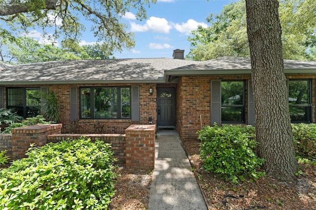473 Burnt Tree Ln, Apopka, FL 32712 - view of front of property with brick siding, a chimney, and a shingled roof