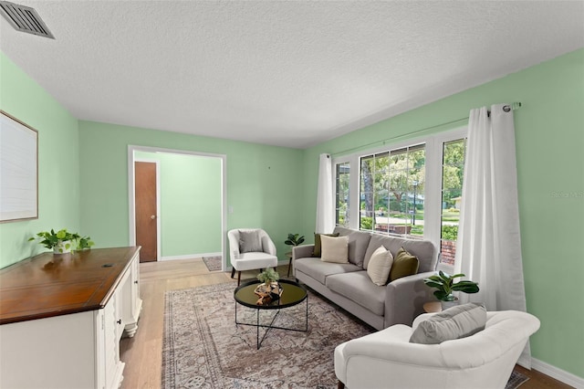 473 Burnt Tree Ln, Apopka, FL 32712 - living area with light wood-style flooring and a textured ceiling