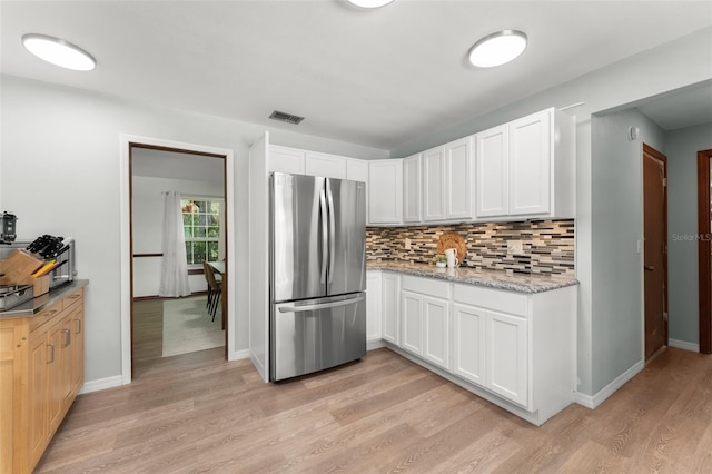 473 Burnt Tree Ln, Apopka, FL 32712 - kitchen with freestanding refrigerator, light wood finished floors, backsplash, and white cabinets