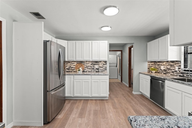 473 Burnt Tree Ln, Apopka, FL 32712 - kitchen with appliances with stainless steel finishes, backsplash, and white cabinets