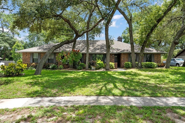 473 Burnt Tree Ln, Apopka, FL 32712 - view of front of property with brick siding, a chimney, and a front yard