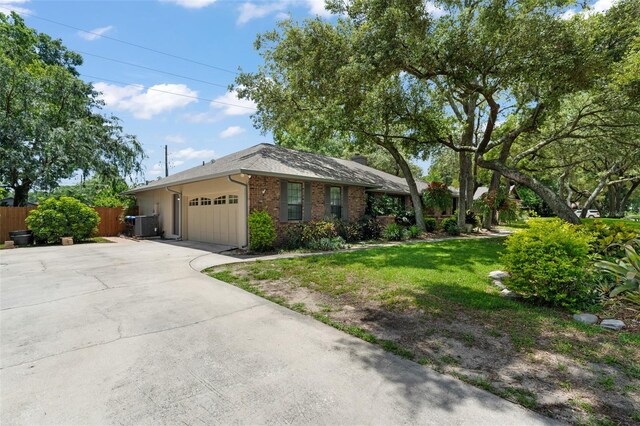 473 Burnt Tree Ln, Apopka, FL 32712 - ranch-style house featuring a garage, driveway, and brick siding