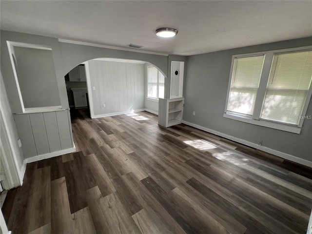 2107 Hollywood Ave, Eustis, FL 32726 - unfurnished room with arched walkways and dark wood-type flooring