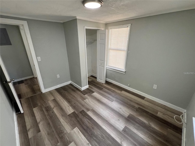 2107 Hollywood Ave, Eustis, FL 32726 - unfurnished bedroom with a closet, dark wood finished floors, and a textured ceiling