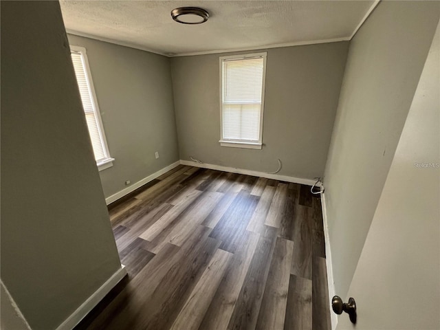 2107 Hollywood Ave, Eustis, FL 32726 - spare room with healthy amount of natural light, dark wood finished floors, and a textured ceiling