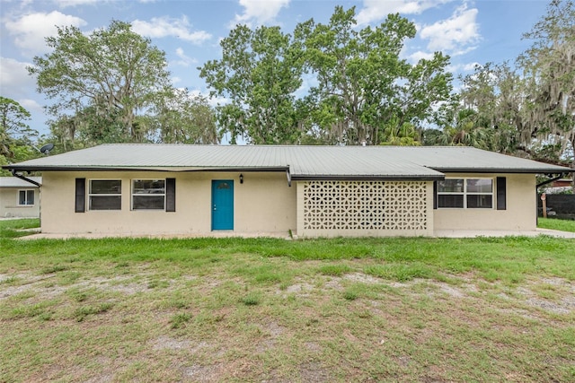 4085 Cypress Bnd, Geneva, FL 32732 - view of front facade with a front yard, stucco siding, and a metal roof