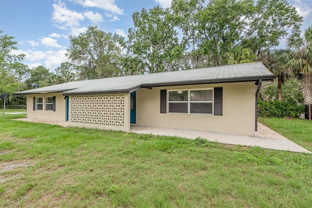 4085 Cypress Bnd, Geneva, FL 32732 - view of front of property with stucco siding, a front yard, and a metal roof