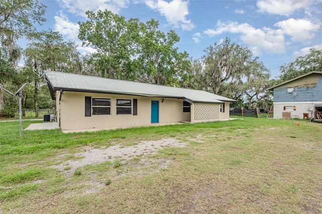 4085 Cypress Bnd, Geneva, FL 32732 - view of front of house featuring a front lawn, stucco siding, and a metal roof