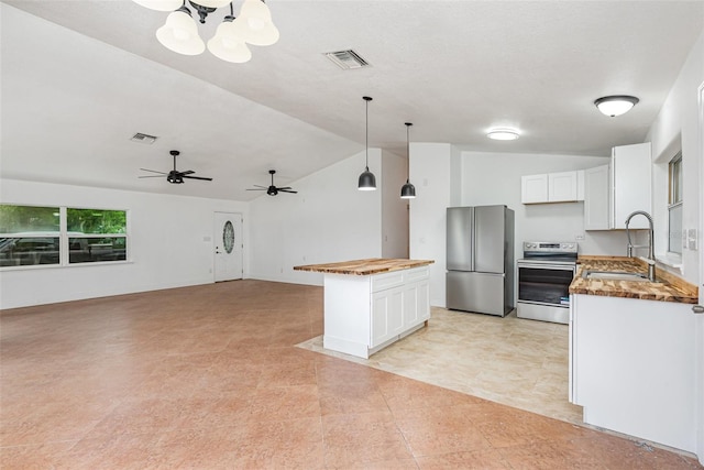 4085 Cypress Bnd, Geneva, FL 32732 - kitchen with appliances with stainless steel finishes, lofted ceiling, white cabinetry, wood counters, and a kitchen island