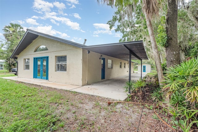4085 Cypress Bnd, Geneva, FL 32732 - view of front of property with french doors, a carport, stucco siding, and driveway