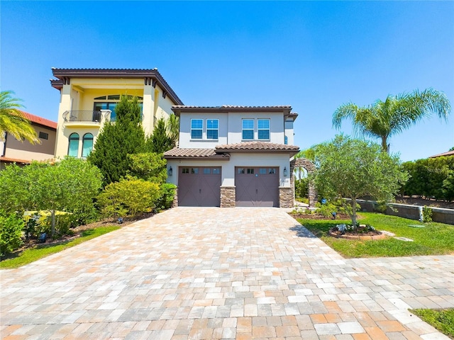 16210 Ravenna Ct, Montverde, FL 34756 - mediterranean / spanish house with an attached garage, stucco siding, decorative driveway, a tiled roof, and stone siding