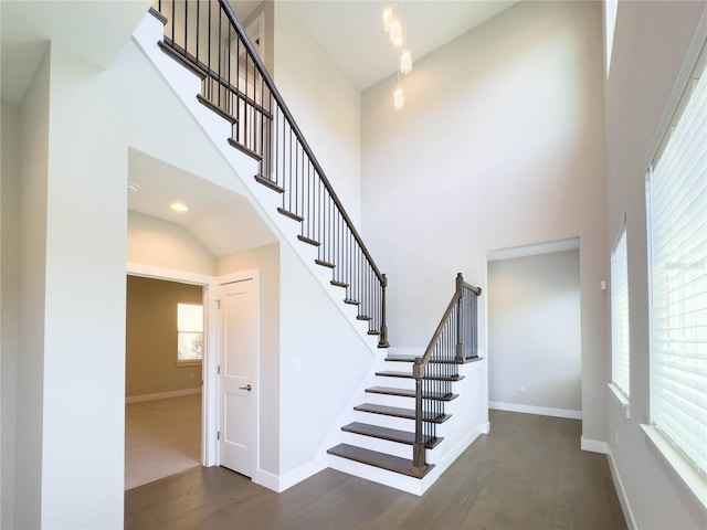 16210 Ravenna Ct, Montverde, FL 34756 - stairway featuring wood finished floors and a towering ceiling