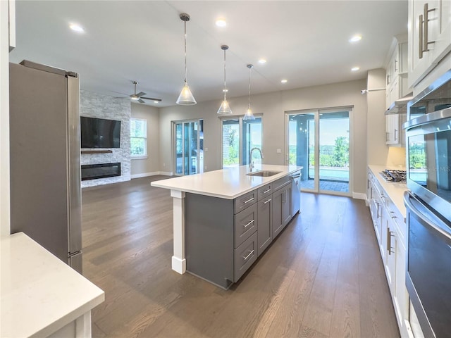 16210 Ravenna Ct, Montverde, FL 34756 - kitchen with gray cabinets, stainless steel appliances, dark wood-style flooring, ceiling fan, and recessed lighting