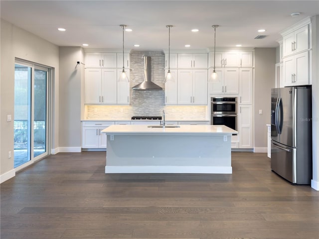 16210 Ravenna Ct, Montverde, FL 34756 - kitchen featuring stainless steel appliances, wall chimney exhaust hood, tasteful backsplash, light countertops, and recessed lighting