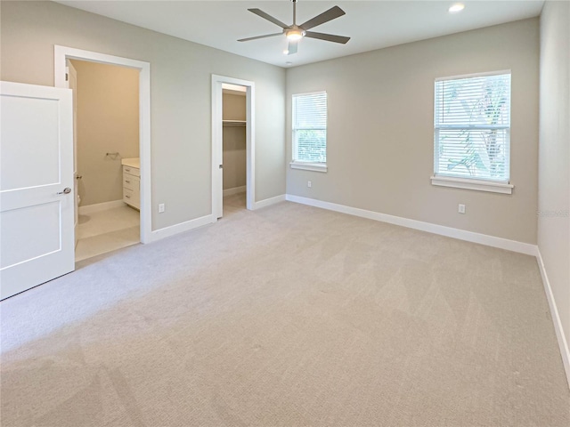 16210 Ravenna Ct, Montverde, FL 34756 - unfurnished bedroom with multiple windows, light carpet, a walk in closet, and ensuite bath