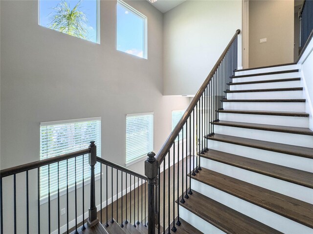 16210 Ravenna Ct, Montverde, FL 34756 - stairs featuring a high ceiling, healthy amount of natural light, and wood finished floors