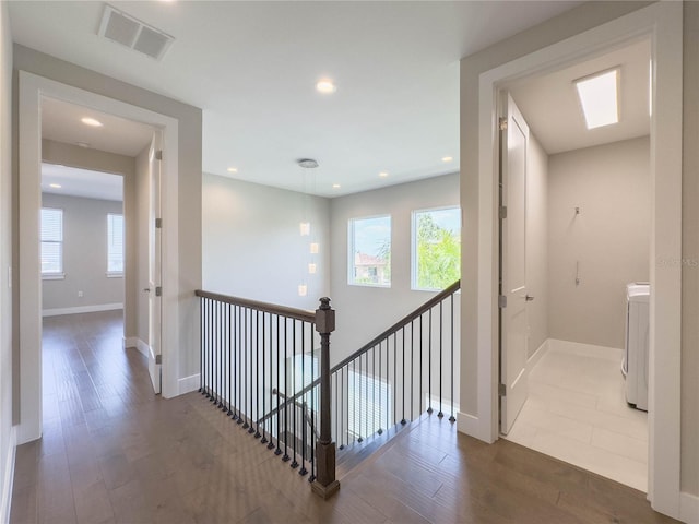 16210 Ravenna Ct, Montverde, FL 34756 - hallway featuring wood finished floors, plenty of natural light, washer / clothes dryer, and recessed lighting