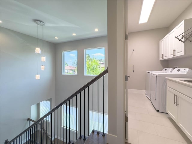 16210 Ravenna Ct, Montverde, FL 34756 - washroom featuring washing machine and clothes dryer, recessed lighting, cabinet space, and light tile patterned floors