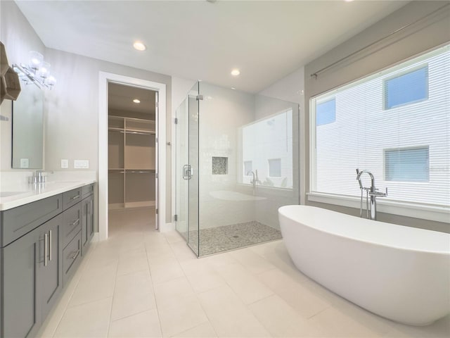 16210 Ravenna Ct, Montverde, FL 34756 - bathroom featuring a shower stall, vanity, a freestanding bath, recessed lighting, and tile patterned flooring