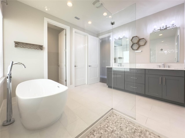 16210 Ravenna Ct, Montverde, FL 34756 - full bathroom featuring double vanity, a freestanding tub, recessed lighting, a shower, and tile patterned flooring