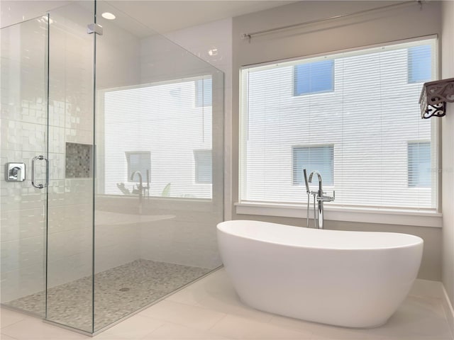 16210 Ravenna Ct, Montverde, FL 34756 - full bath featuring a stall shower, a freestanding bath, and tile patterned floors