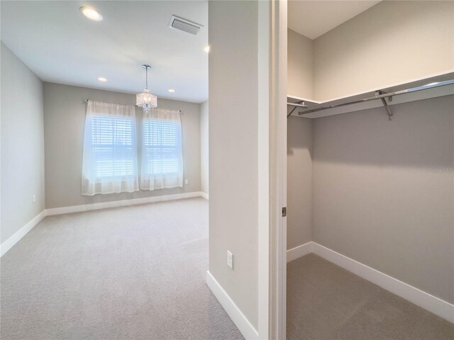 16210 Ravenna Ct, Montverde, FL 34756 - walk in closet featuring carpet flooring and a chandelier