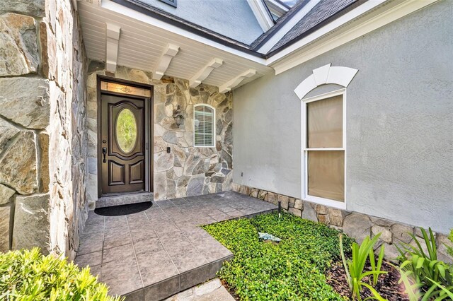 413 Harbour Oaks Pointe Dr, Edgewood, FL 32809 - entrance to property featuring stone siding and stucco siding