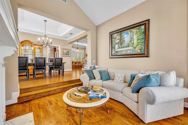 413 Harbour Oaks Pointe Dr, Edgewood, FL 32809 - living room with a chandelier, wood finished floors, crown molding, a tray ceiling, and lofted ceiling