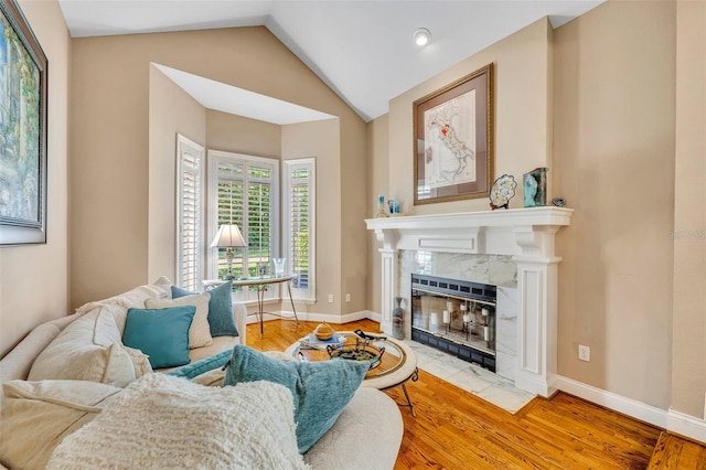 413 Harbour Oaks Pointe Dr, Edgewood, FL 32809 - living area featuring lofted ceiling, a high end fireplace, and wood finished floors