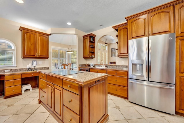 413 Harbour Oaks Pointe Dr, Edgewood, FL 32809 - kitchen featuring stainless steel refrigerator with ice dispenser, black electric stovetop, light tile patterned flooring, a center island, and recessed lighting