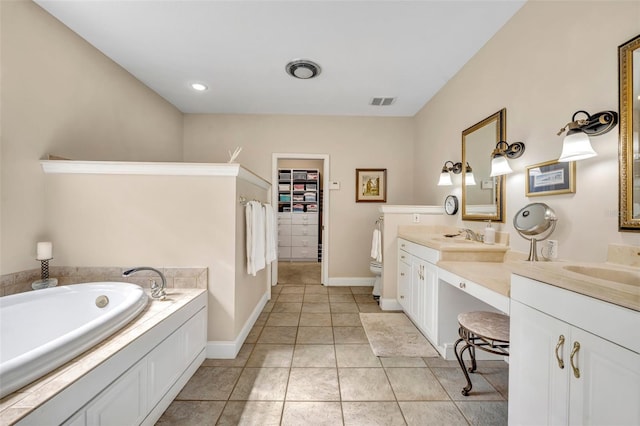 413 Harbour Oaks Pointe Dr, Edgewood, FL 32809 - bathroom featuring vanity, a garden tub, tile patterned floors, and a spacious closet