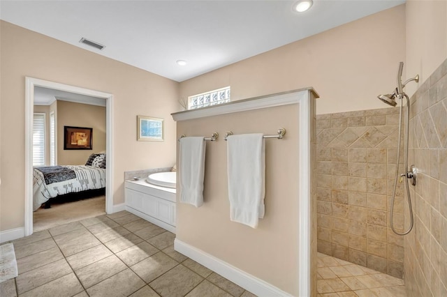 413 Harbour Oaks Pointe Dr, Edgewood, FL 32809 - ensuite bathroom featuring a tile shower, tile patterned floors, healthy amount of natural light, and a garden tub