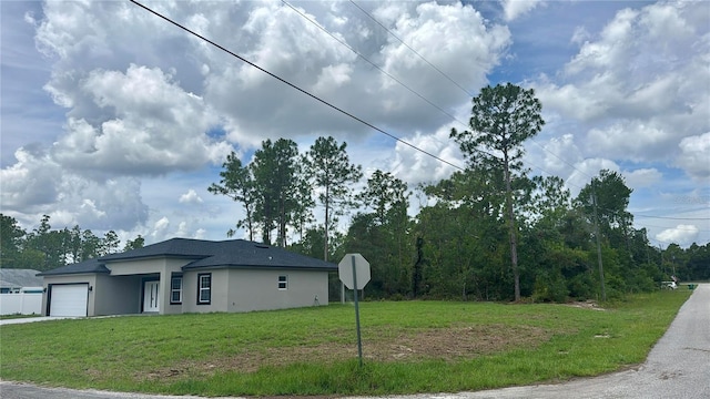 7215 N Westbrook Way, Citrus Springs, FL 34433 - view of property exterior with stucco siding, a garage, a yard, and concrete driveway
