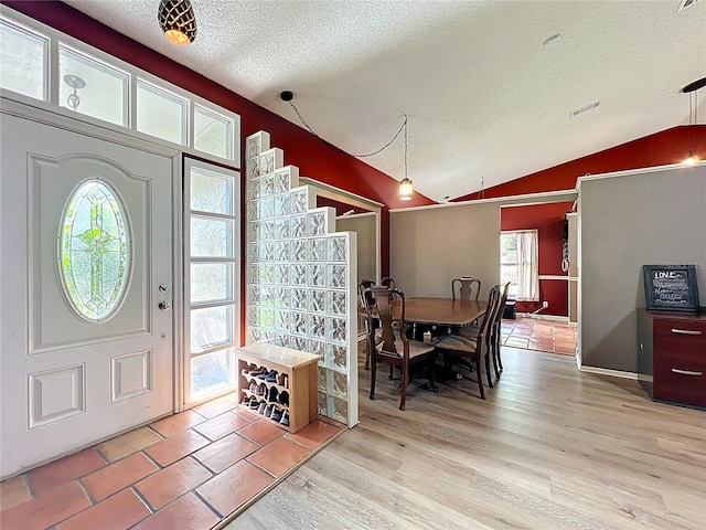 1044 Dees Dr, Oviedo, FL 32765 - entrance foyer with lofted ceiling, a textured ceiling, healthy amount of natural light, and light wood-type flooring