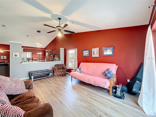 1044 Dees Dr, Oviedo, FL 32765 - living room with wood finished floors, a ceiling fan, lofted ceiling, and a textured ceiling