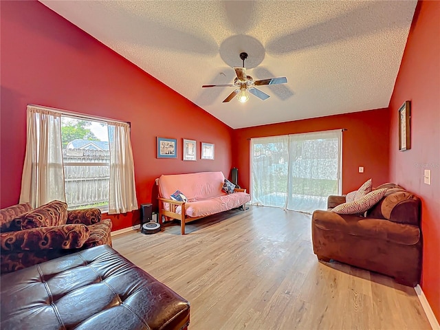 1044 Dees Dr, Oviedo, FL 32765 - living room featuring a textured ceiling, a ceiling fan, lofted ceiling, and wood finished floors