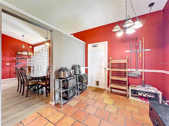 1044 Dees Dr, Oviedo, FL 32765 - dining space featuring a textured ceiling, a chandelier, and vaulted ceiling