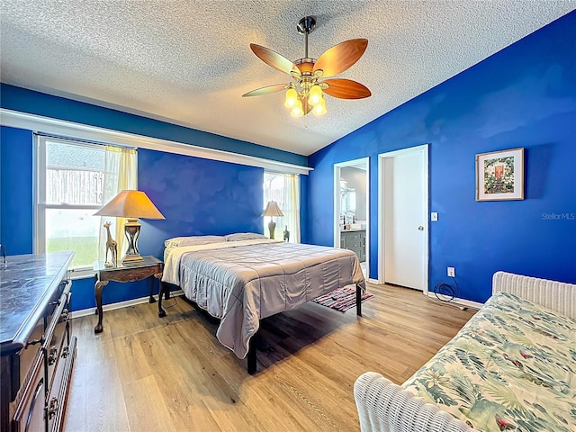 1044 Dees Dr, Oviedo, FL 32765 - bedroom with vaulted ceiling, a textured ceiling, light wood-type flooring, multiple windows, and a ceiling fan